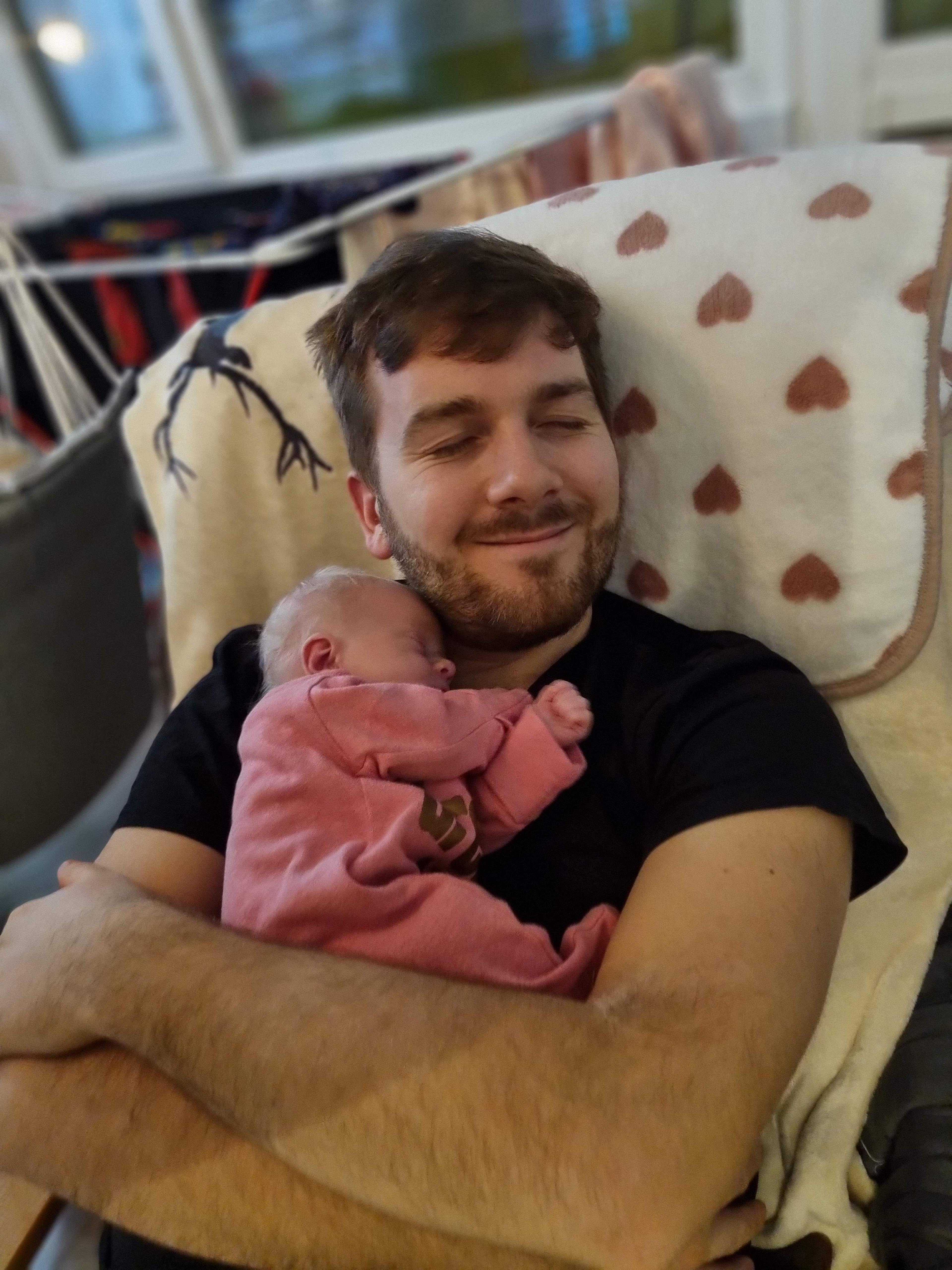 Patrik holding his newborn daughter