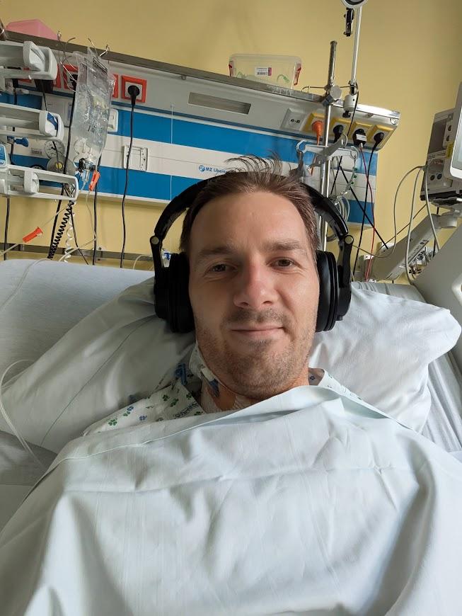 Patrik recovering after third surgery with headphones