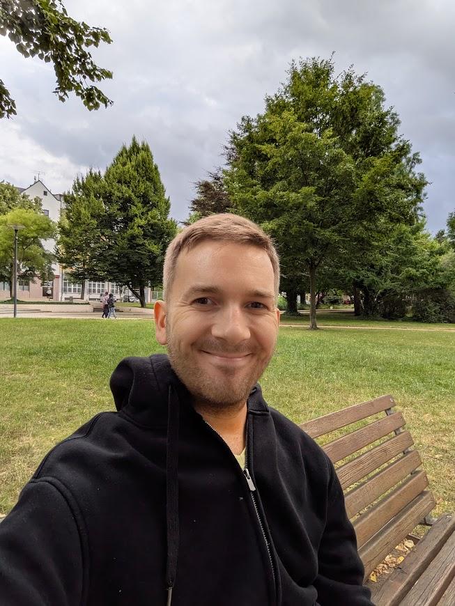 Patrik sitting on a bench in PodÄbrady rehabilitation center park